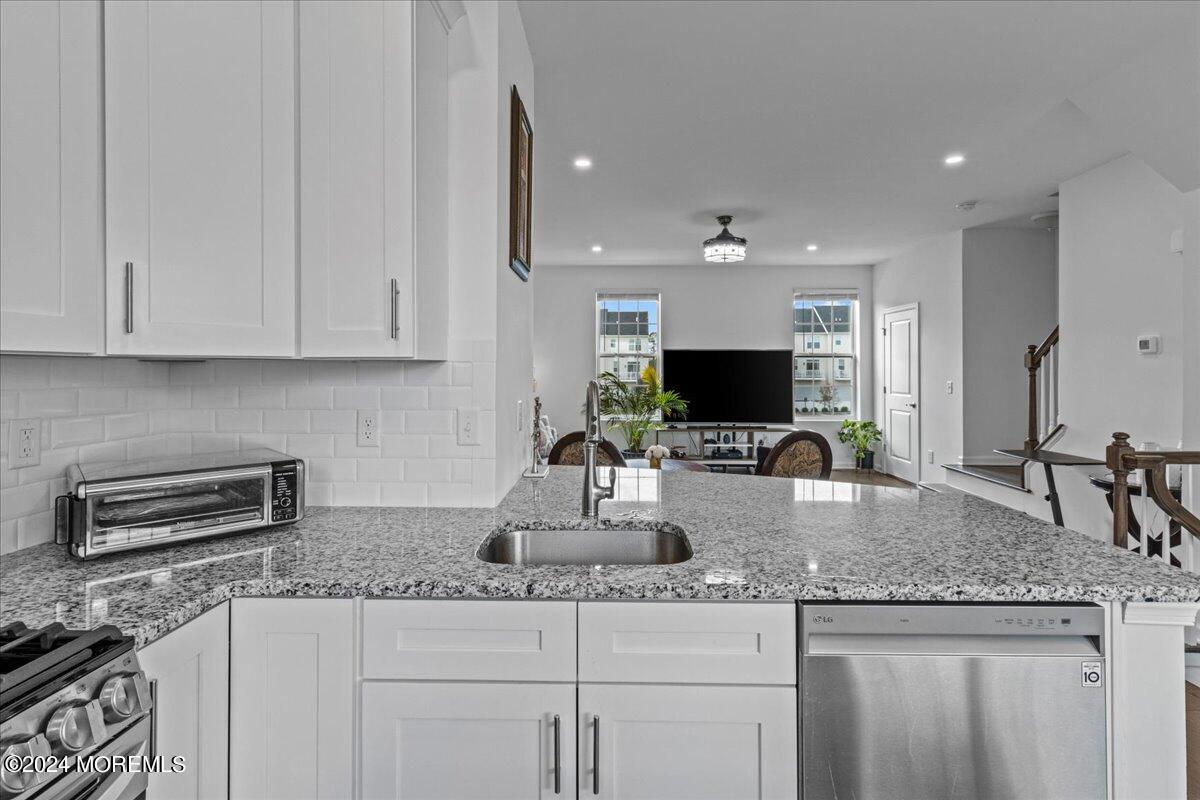 104 Prestige Road Brick, NJ 08723 - Photo 4 of 43 a kitchen with granite countertop a sink and white cabinets