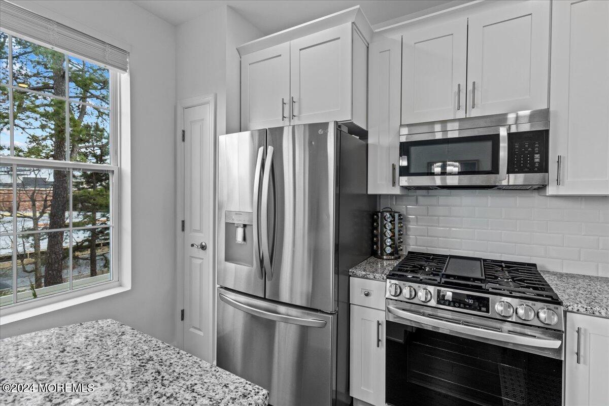 104 Prestige Road Brick, NJ 08723 - Photo 6 of 43 a kitchen with stainless steel appliances granite countertop a stove a refrigerator and a stove