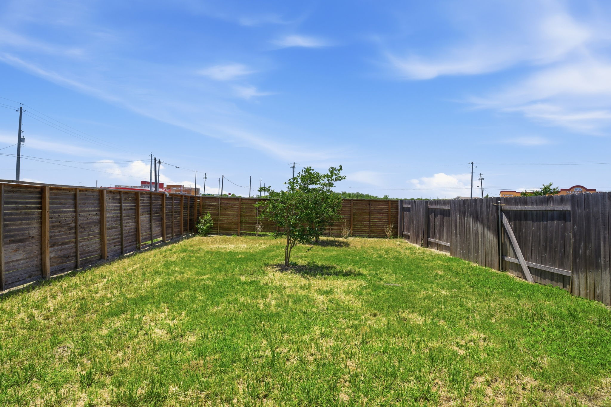 12213 Rising Moon Lane Del Valle, TX 78617 - Photo 18 of 19 a garden with trees in front of it