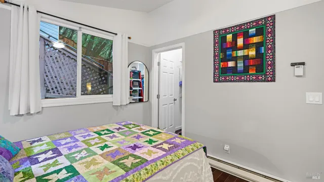 a bedroom with a bed and a window