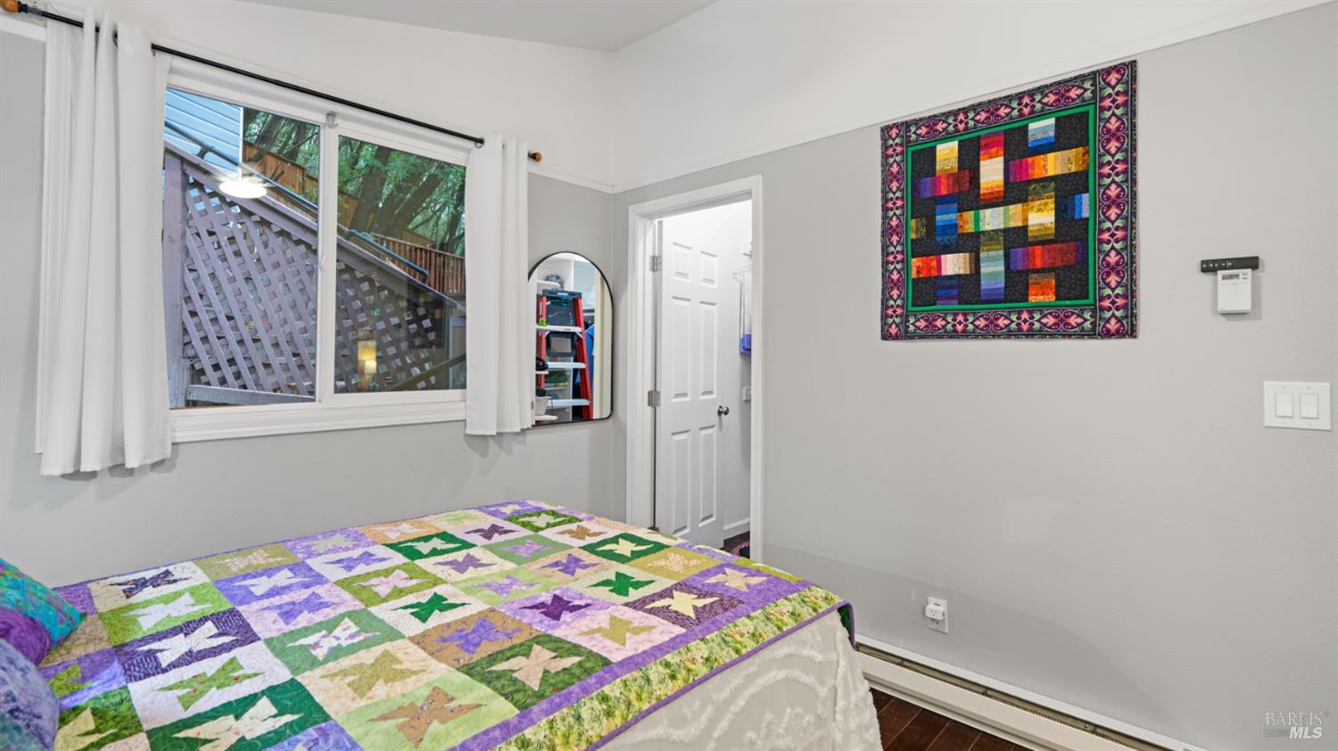 15246 Rio Nido Road Guerneville, CA 95446 - Photo 11 of 24 a bedroom with a bed and a window