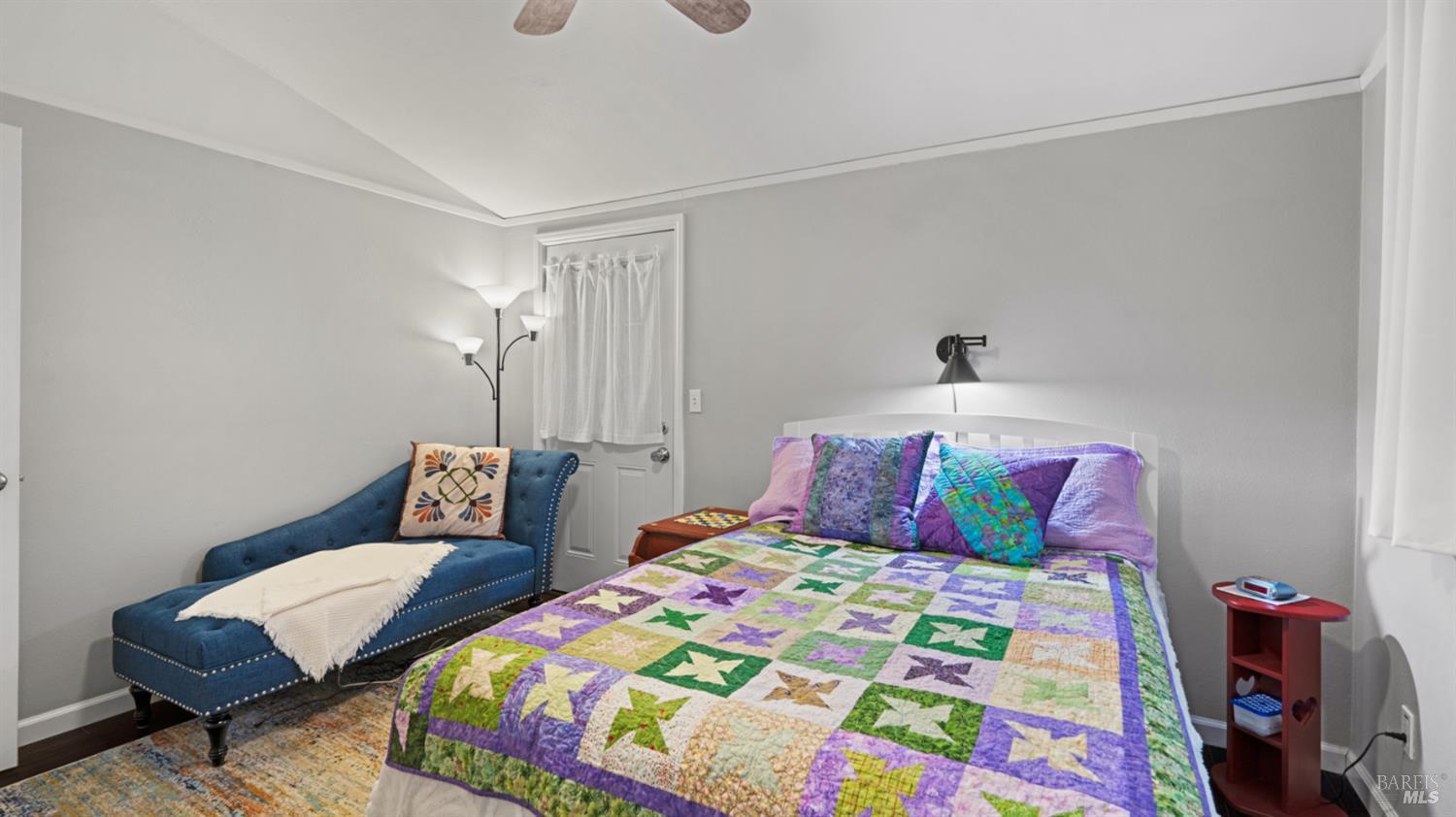 15246 Rio Nido Road Guerneville, CA 95446 - Photo 12 of 24 a bedroom with a bed that has a blanket on it and next to a wall