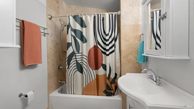 a bathroom with a sink a mirror and a window