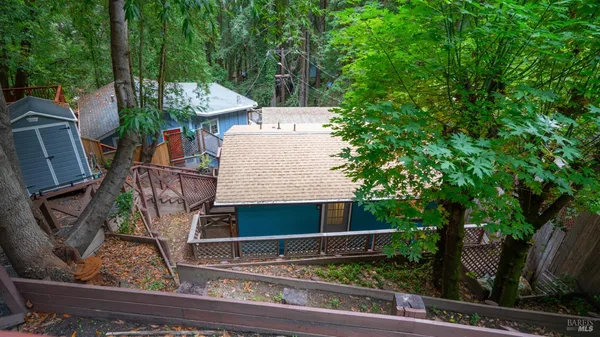 a view of a chairs and table in the backyard