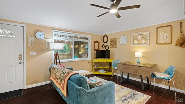 a living room with furniture and wooden floor