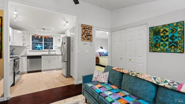 a kitchen that has a lot of cabinets and wooden floor