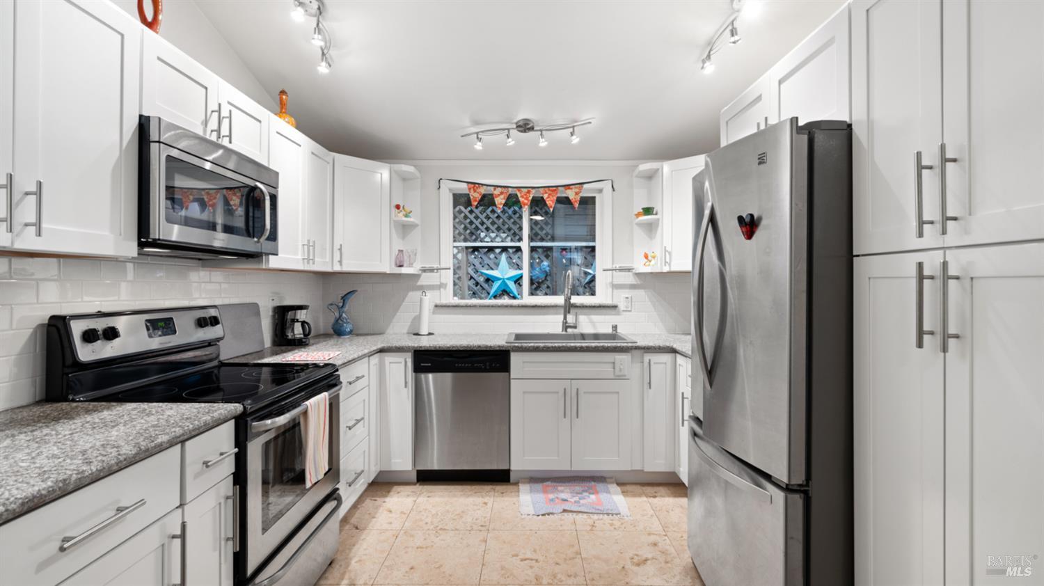15246 Rio Nido Road Guerneville, CA 95446 - Photo 7 of 24 a kitchen with stainless steel appliances granite countertop a refrigerator sink and stove