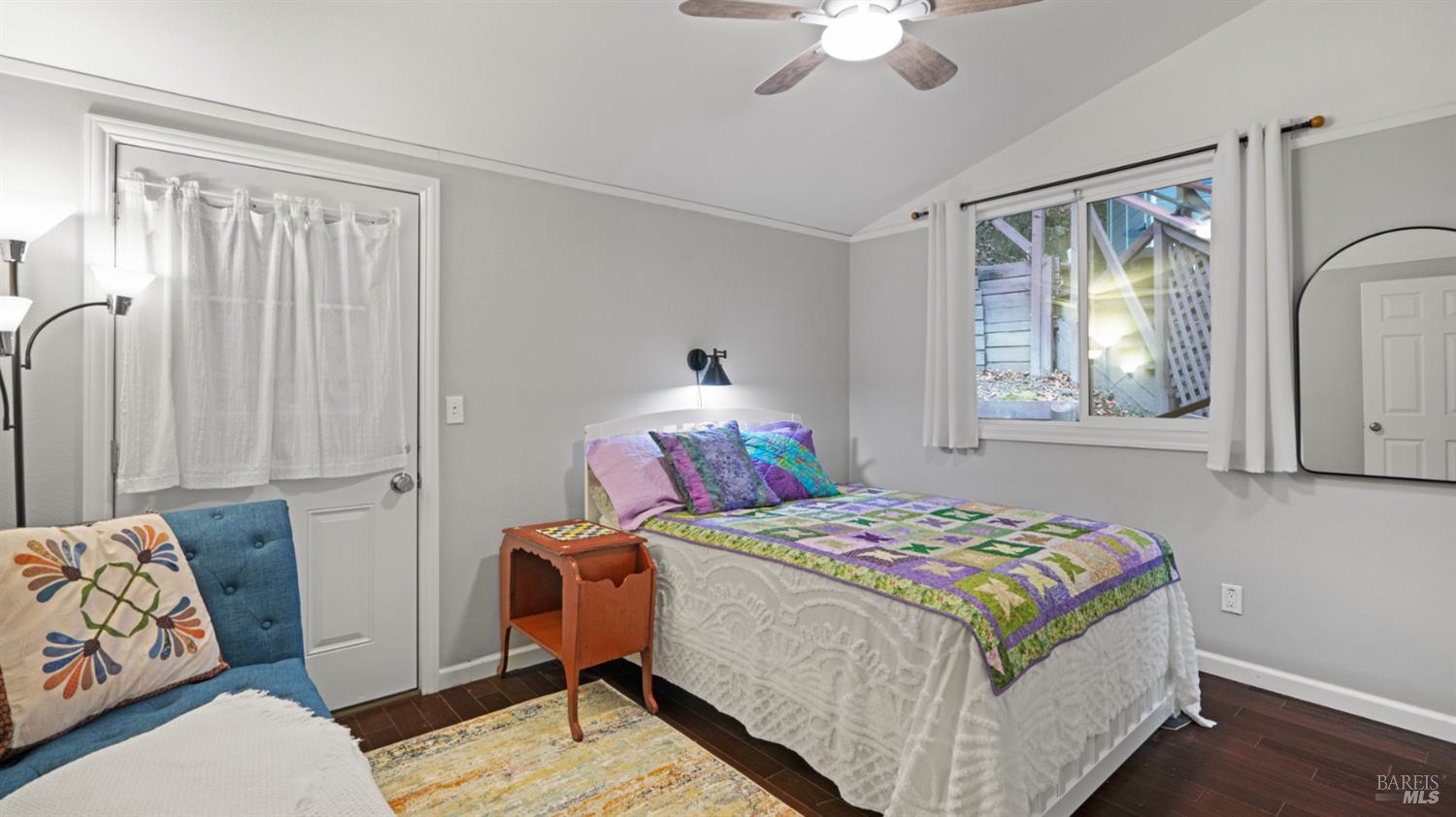 15246 Rio Nido Road Guerneville, CA 95446 - Photo 10 of 24 a bedroom that has a bed and a chandelier