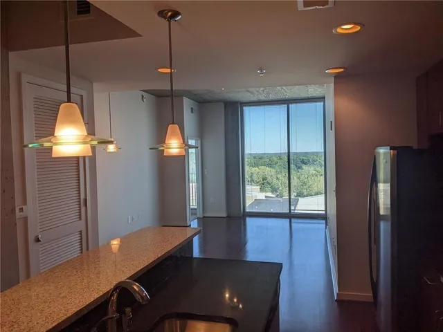 a view of a room with furniture and a window