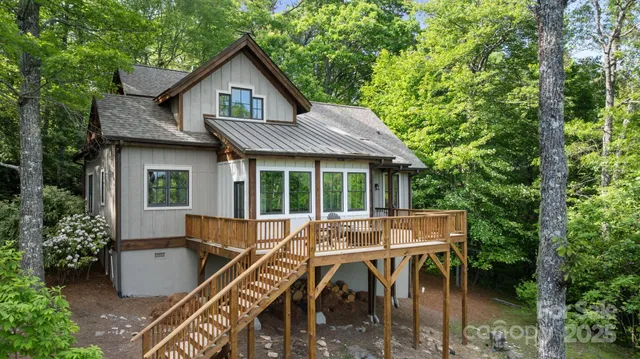 a view of house with a yard and furniture