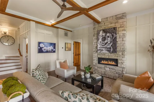 a living room with furniture and a wall painting