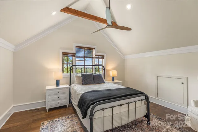 a bedroom with a bed and a night stand