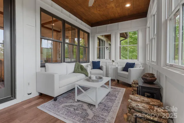 an aerial view of a house with a yard and large trees
