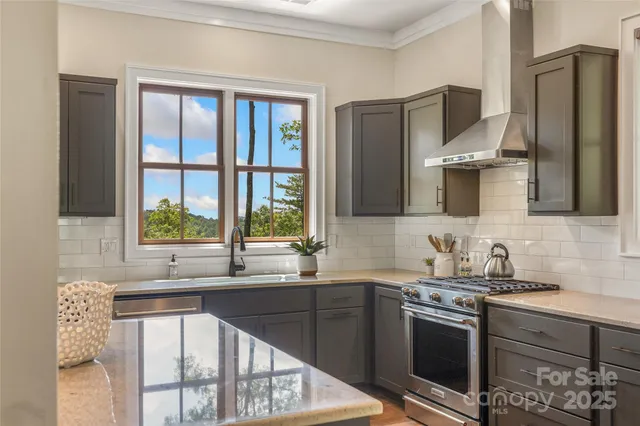 a kitchen with stainless steel appliances granite countertop a sink stove and refrigerator