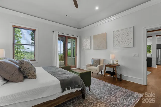 a bedroom with a bed and a table in it with wooden floor