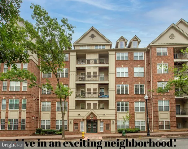 a front view of a residential apartment building with a yard