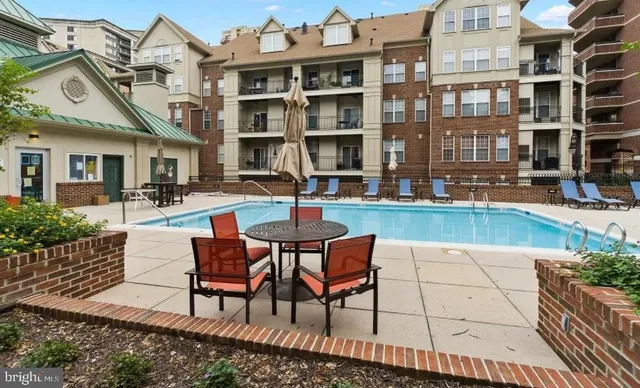 a swimming pool view with a outdoor seating
