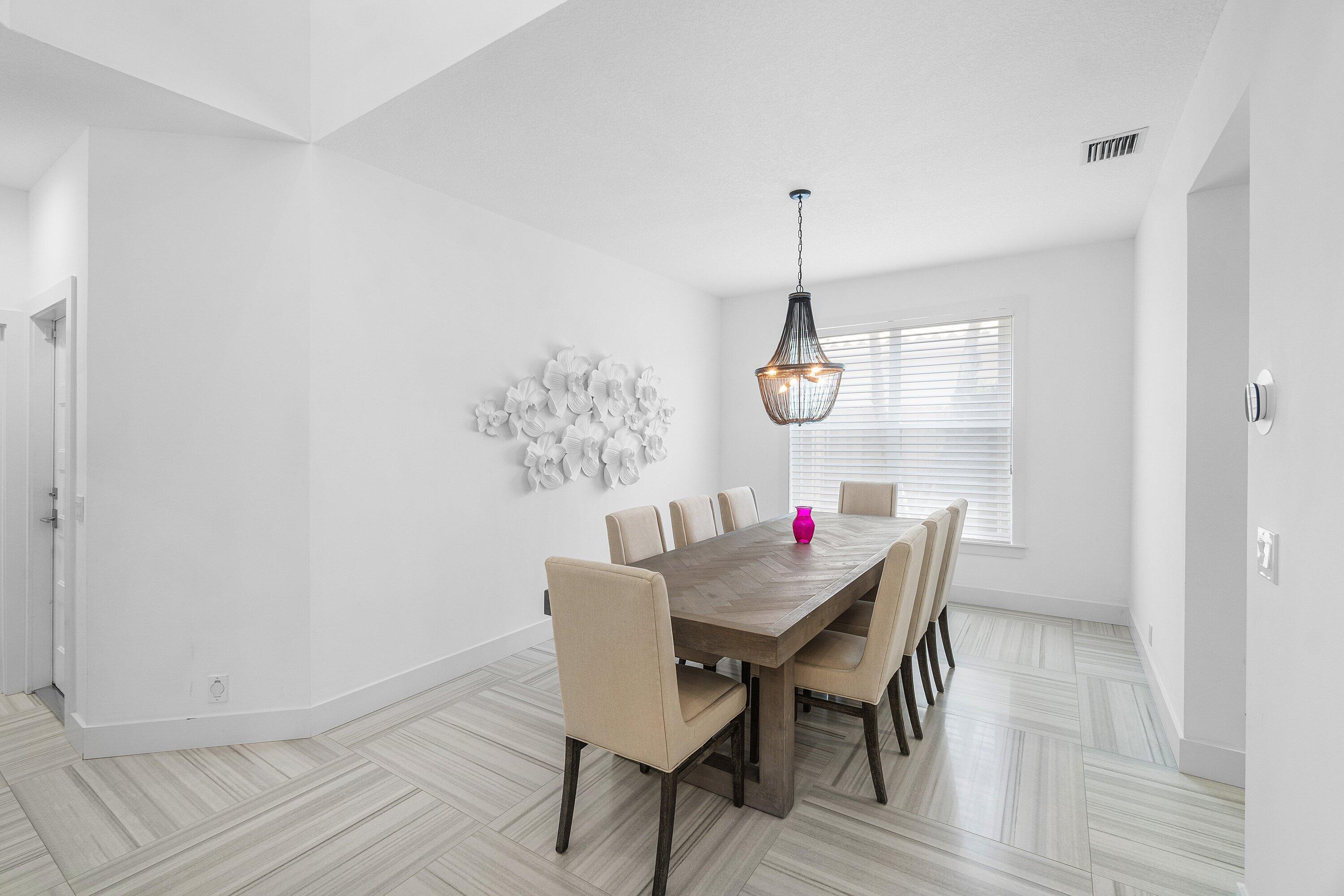 2404 Northwest 67th Street Boca Raton, FL 33496 - Photo 7 of 74 a view of a dining room with furniture and wooden floor