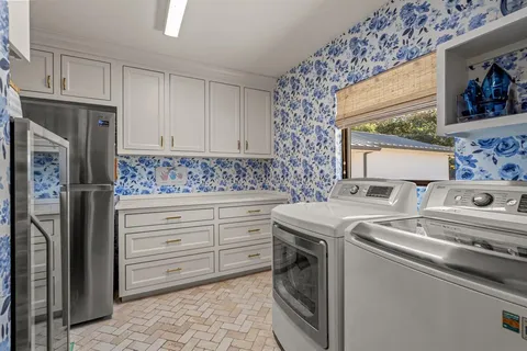 a kitchen with granite countertop a sink stove and refrigerator