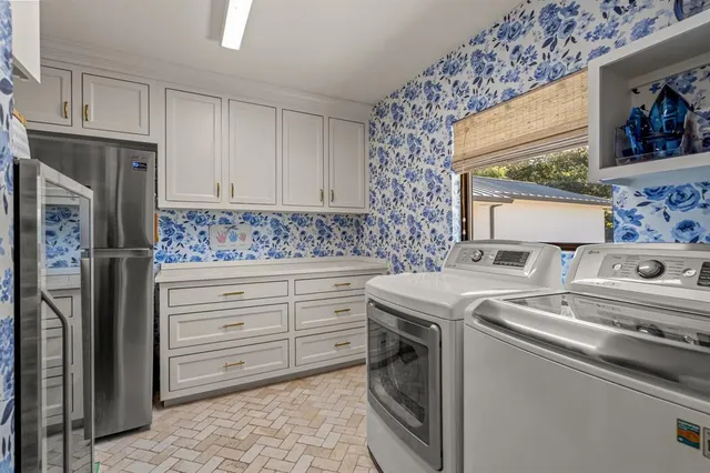 a kitchen with granite countertop a sink stove and refrigerator