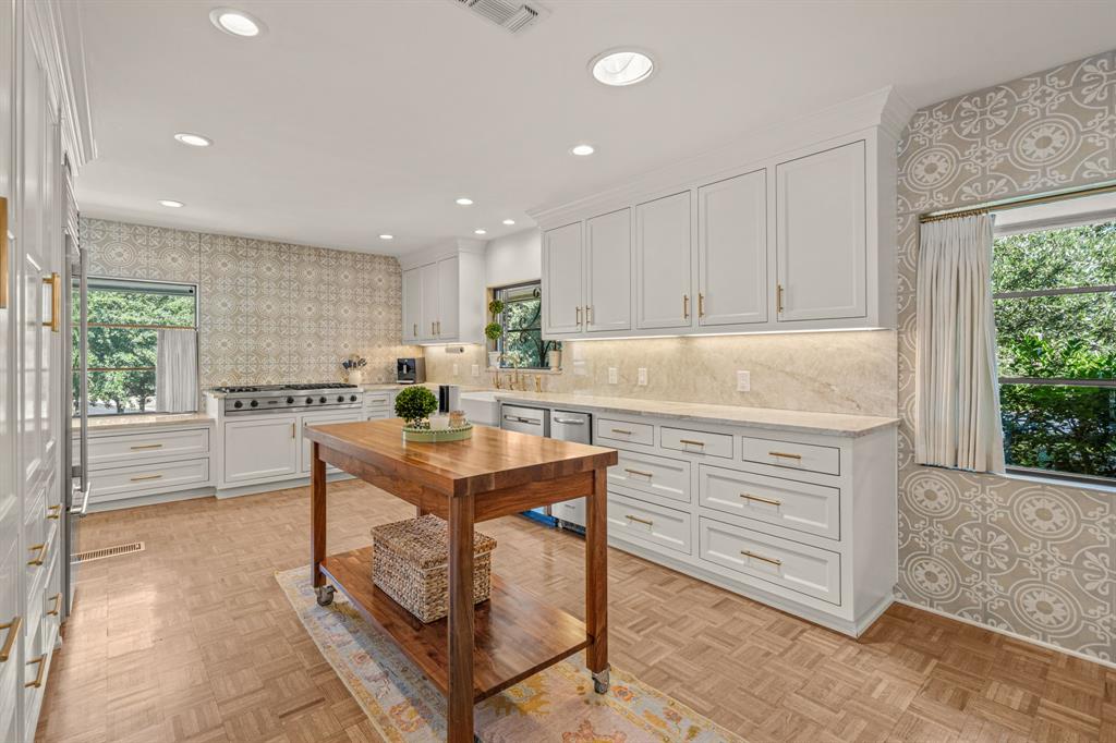 5849 Merrymount Road Westover Hills, TX 76107 - Photo 19 of 40 a kitchen with kitchen island a stove a sink a refrigerator and blue cabinets with wooden floor