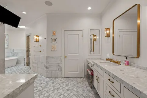 a spacious bathroom with a double vanity sink mirror and shower