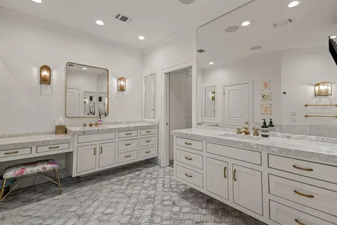 a spacious bathroom with a granite countertop sink mirror and a