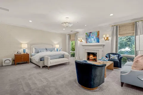 a bedroom with a bed and a fireplace