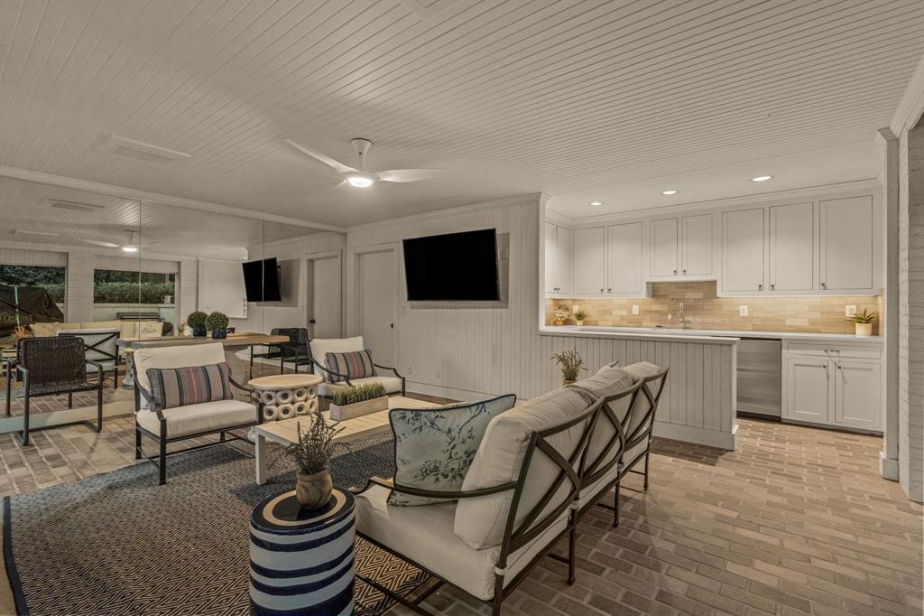5849 Merrymount Road Westover Hills, TX 76107 - Photo 27 of 32 a living room with furniture a flat screen tv and kitchen view