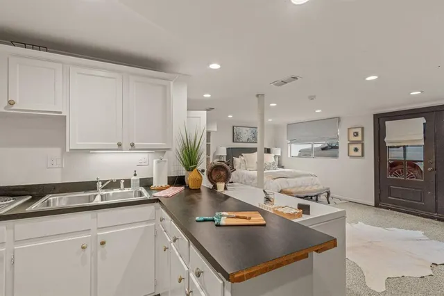 a kitchen with stainless steel appliances granite countertop a sink a stove and a refrigerator