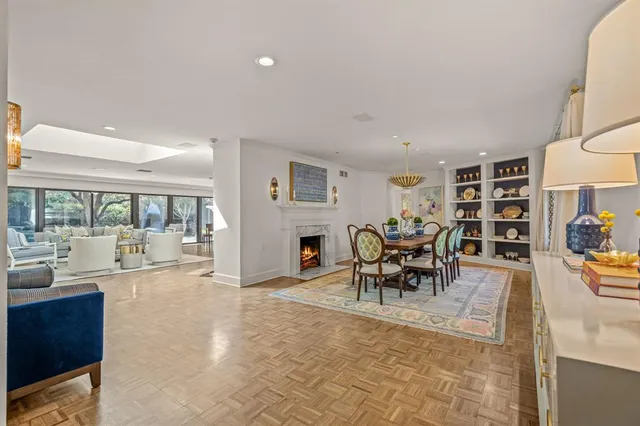 a living room with furniture and a dining table with rug