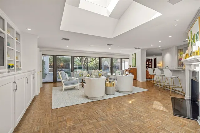 a living room with fireplace furniture and a large window