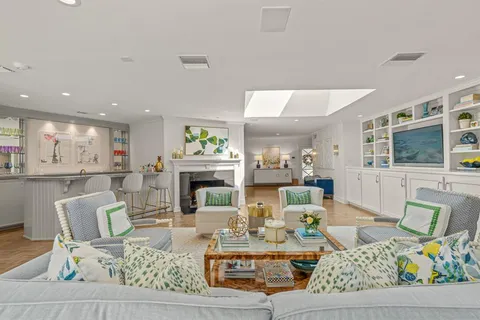 a living room with fireplace furniture and a flat screen tv