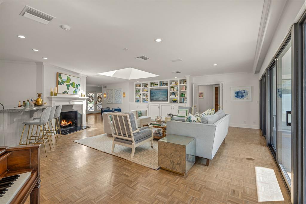 5849 Merrymount Road Westover Hills, TX 76107 - Photo 9 of 40 a living room with furniture a fireplace and a dining table with wooden floor