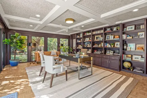 a living room with furniture a bookshelf and a book shelf