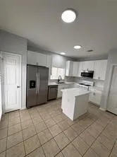 a kitchen with stainless steel appliances granite countertop a refrigerator sink and cabinets
