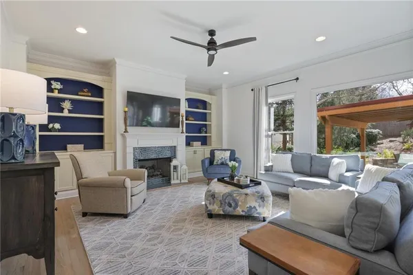 a living room with furniture fireplace and flat screen tv