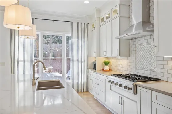 a kitchen with stainless steel appliances granite countertop a stove a sink and a refrigerator
