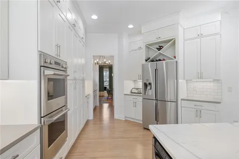 a kitchen with stainless steel appliances a refrigerator and a stove top oven