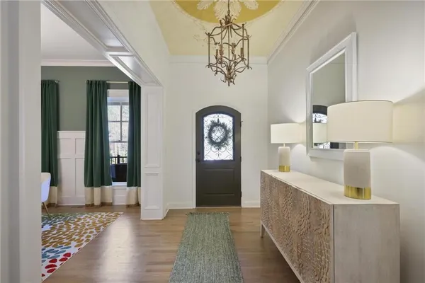 a view of a hallway with a sink and chandelier