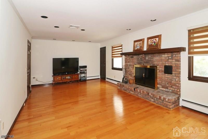 5 Sleepy Hollow Road Edison, NJ 08820 - Photo 11 of 24 a living room with furniture flat screen tv and a fireplace