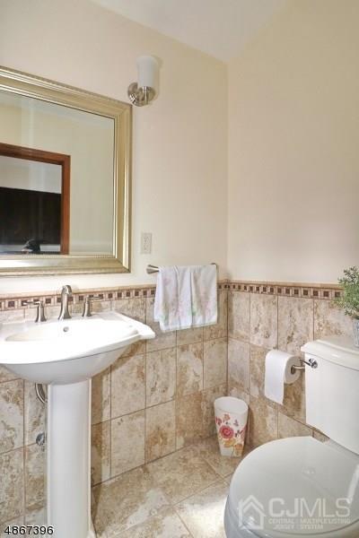 5 Sleepy Hollow Road Edison, NJ 08820 - Photo 14 of 24 a bathroom with a sink and a mirror