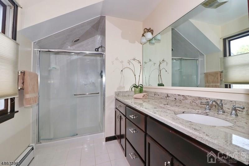 5 Sleepy Hollow Road Edison, NJ 08820 - Photo 17 of 24 a bathroom with a granite countertop shower sink and mirror
