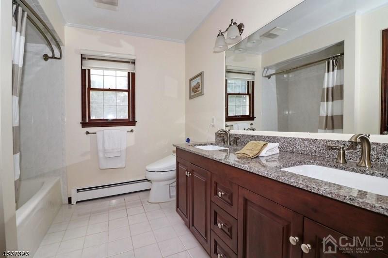 5 Sleepy Hollow Road Edison, NJ 08820 - Photo 20 of 24 a spacious bathroom with a granite countertop double vanity sink a mirror and a
