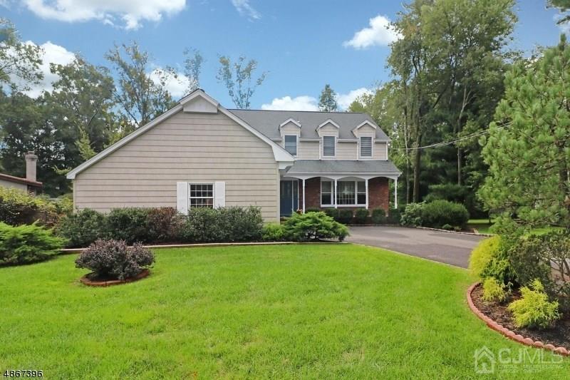 5 Sleepy Hollow Road Edison, NJ 08820 - Photo 2 of 24 a front view of a house with a yard and garage