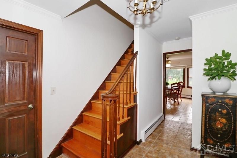 5 Sleepy Hollow Road Edison, NJ 08820 - Photo 4 of 24 a view of a hallway with dining room and chandelier