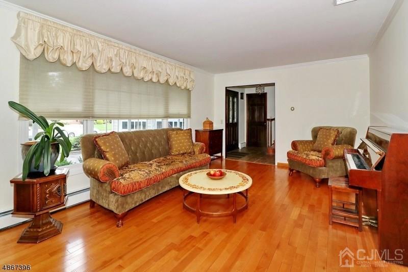 5 Sleepy Hollow Road Edison, NJ 08820 - Photo 5 of 24 a living room with furniture and a wooden floor