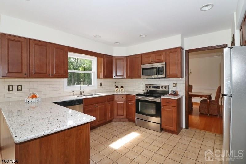 5 Sleepy Hollow Road Edison, NJ 08820 - Photo 8 of 24 a kitchen with stainless steel appliances granite countertop a stove sink microwave and refrigerator