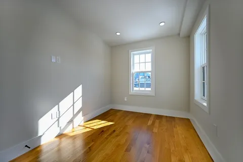 wooden floor in an empty room with a window