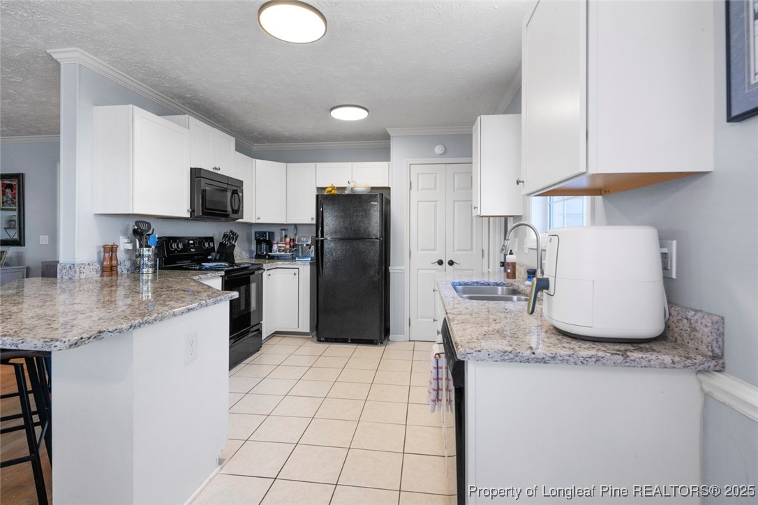 59 Prestige Drive Cameron, NC 28326 - Photo 11 of 36 a kitchen with granite countertop a sink a stove a refrigerator a washer and dryer